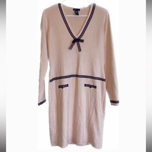 Pale pink sweater‎ dress with black trim.